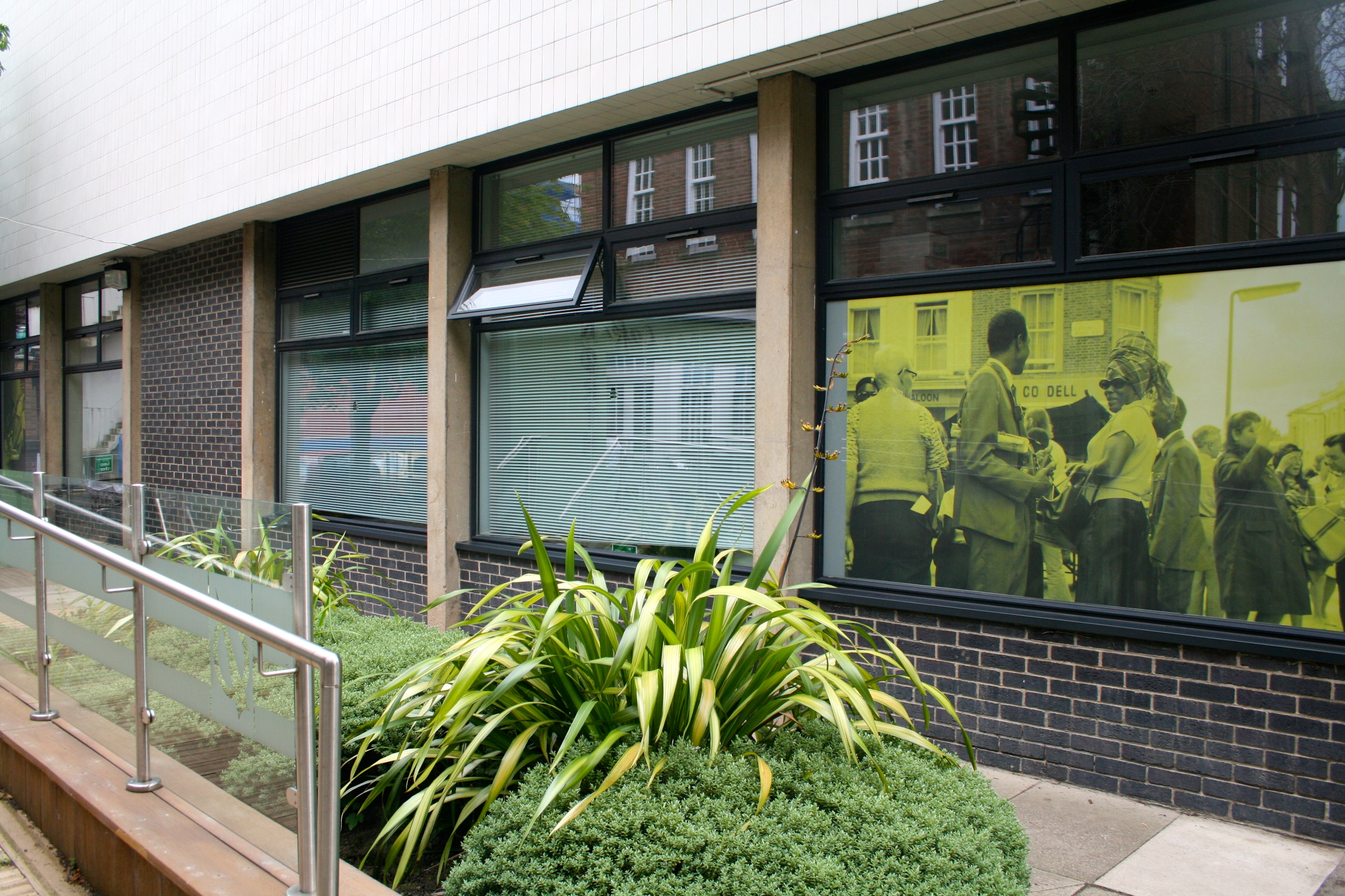 Photograph of the Museum Studies building with one of the 100 Images printed onto one of the windows