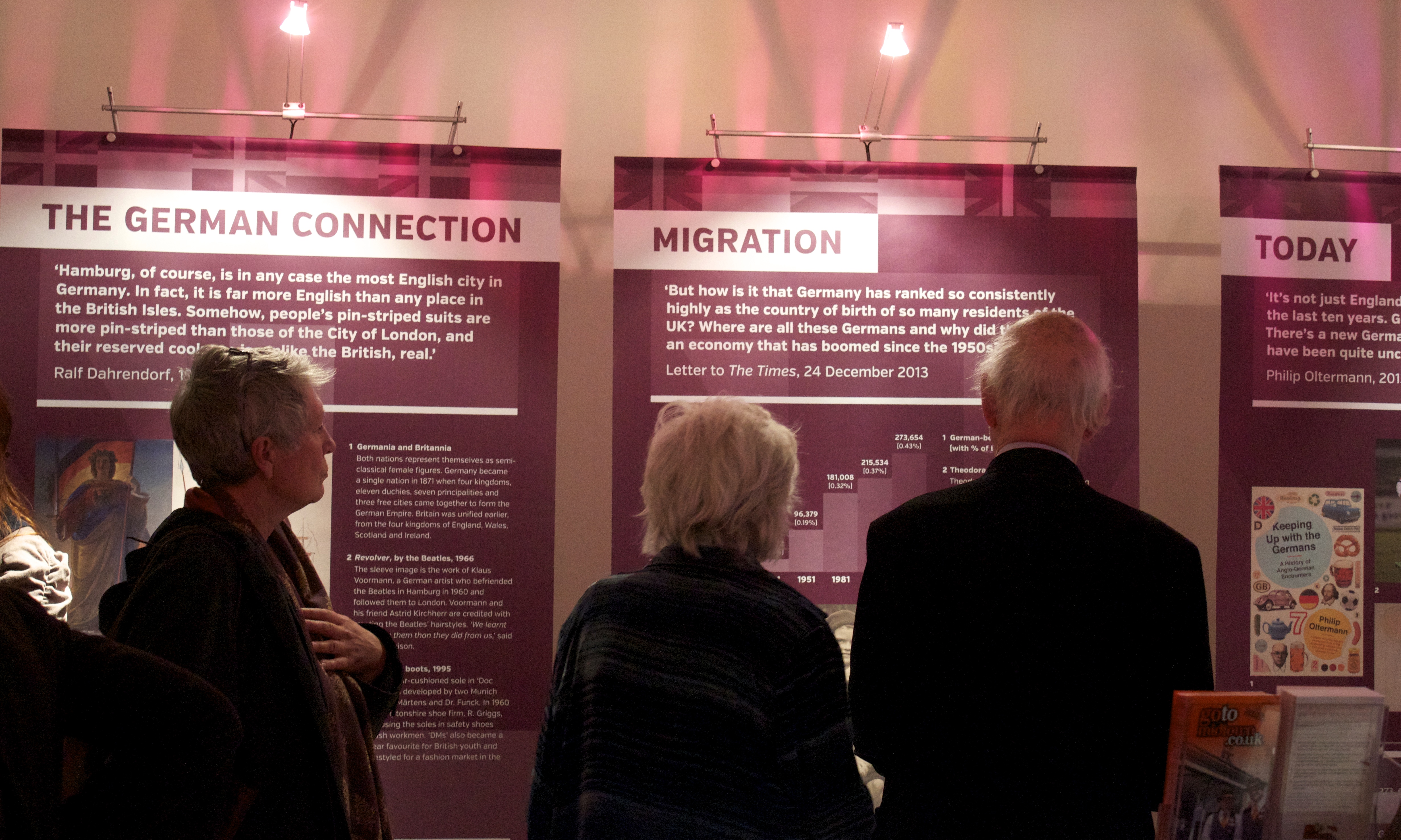 Guests look at Germans in Britain exhibition panels: 'The German Connection', 'Migration' and 'Today'